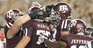 Sep 12, 2015; College Station, TX, USA; Texas A&M Aggies offensive lineman Koda Martin (75) is congratulated after falling on a fumble in the end zone for a touchdown against the Ball State Cardinals in the second half at Kyle Field. Aggies won 56 to 23. Mandatory Credit: Thomas B. Shea-USA TODAY Sports